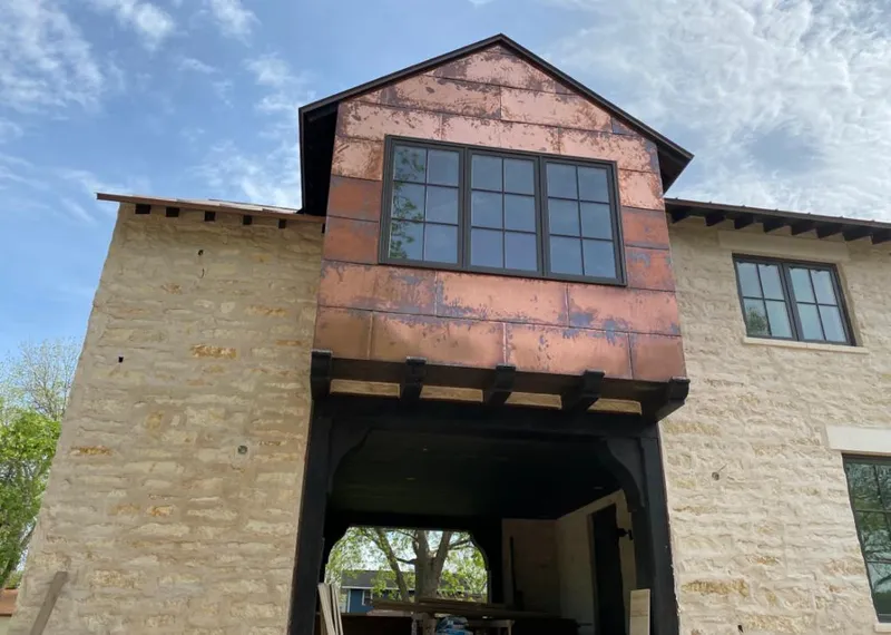 Copper metal panel facade on a stone building for Roof Repair in Miami Lakes
