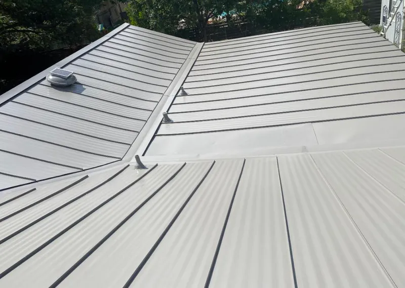 Solar attic fan installed on a metal roof for Roof Ventilation in Miami Lakes